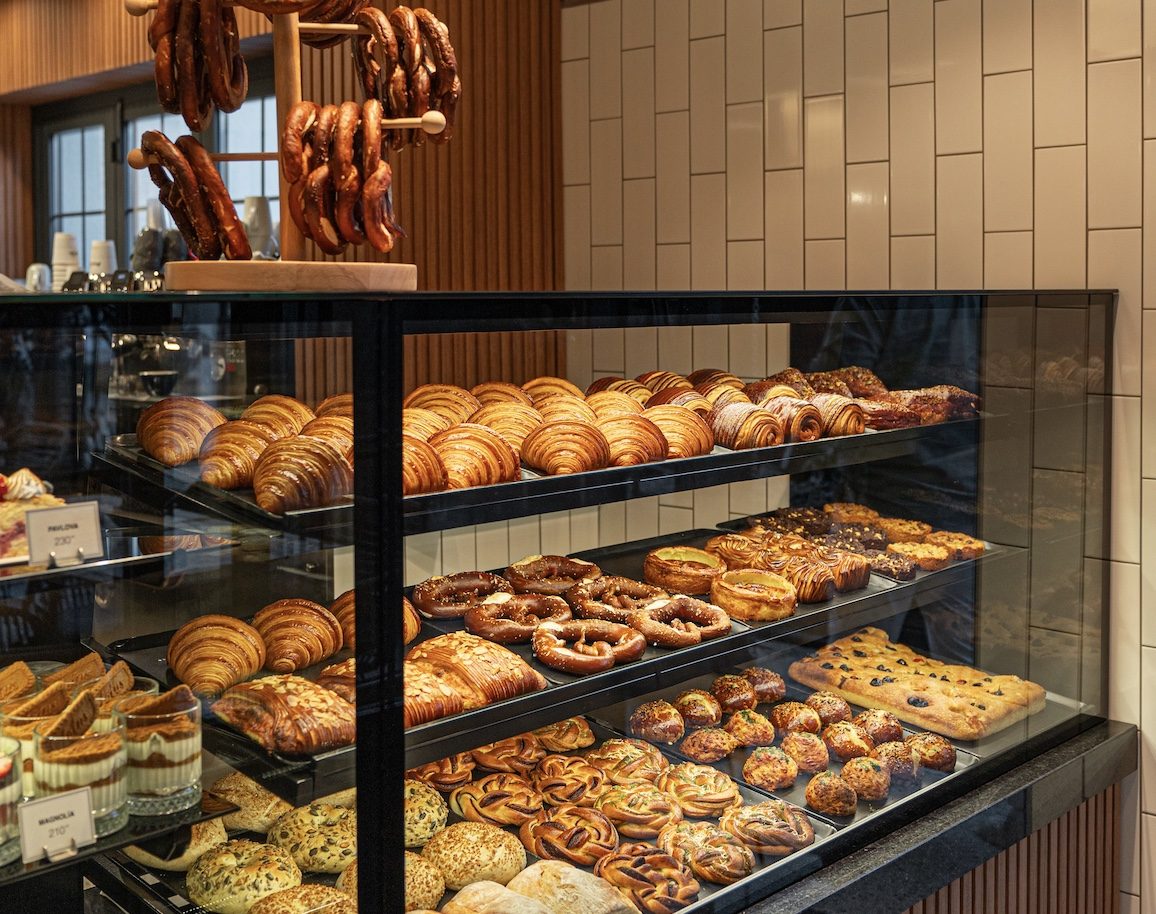 Bakery counter with croissants, pretzels and buns.